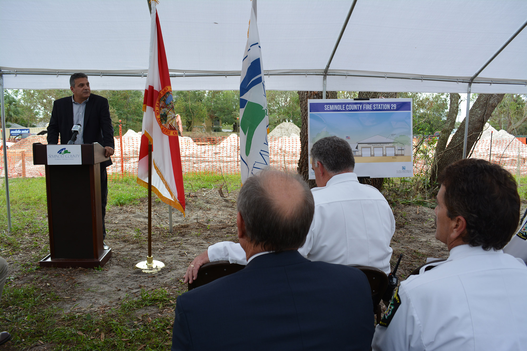 Speaker at Seminole County fire station event under outdoor tent